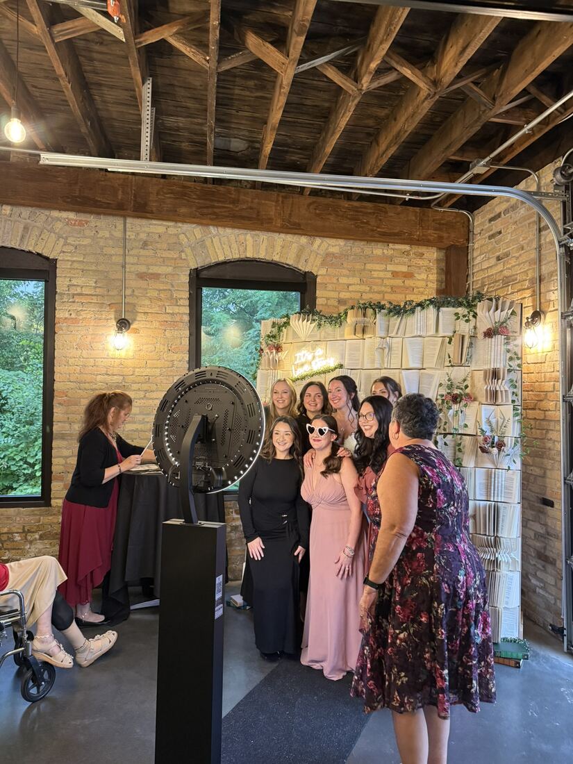 Wedding guests posing together at the selfie station